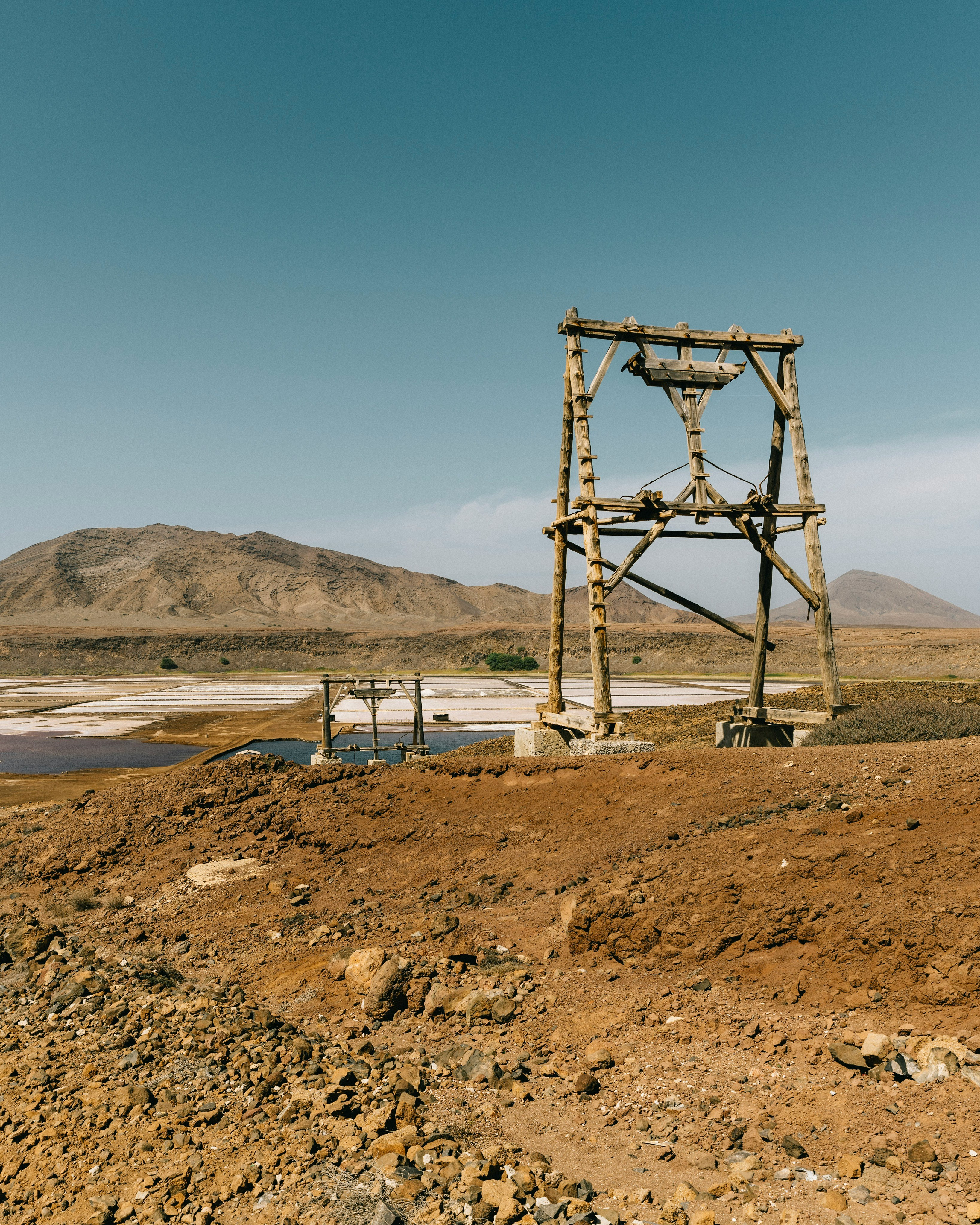 brown wooden tower near body of water during daytime